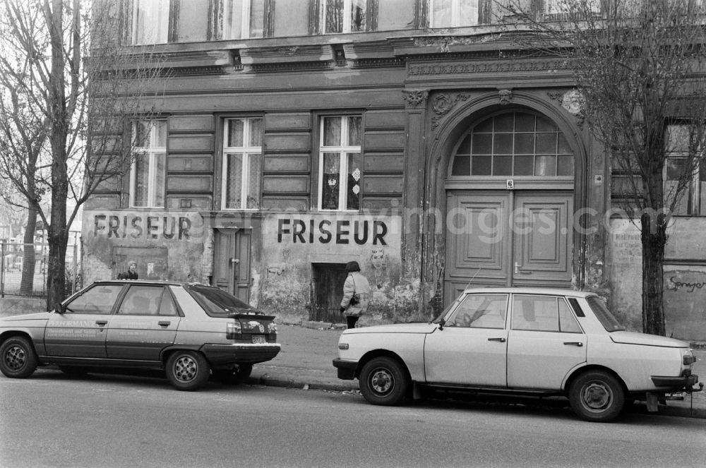 GDR image archive: Berlin - Street scene in front of a dilapidated old building facade with the words Barber in Berlin - Prenzlauer Berg, the former capital of the GDR, German Democratic Republic
