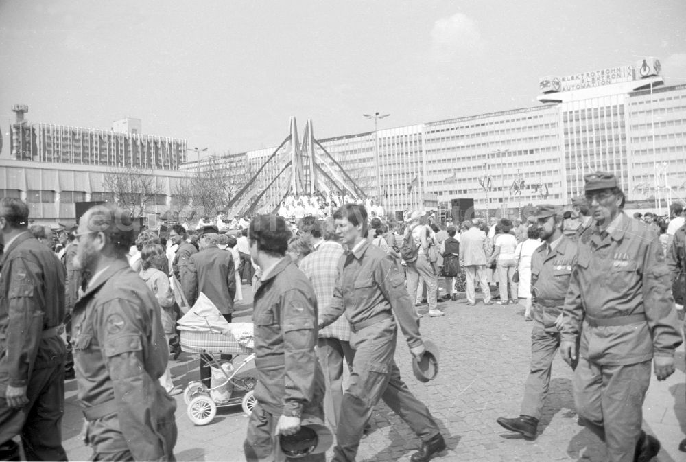 GDR photo archive: Berlin - Working people and members of the uniformed combat troops leave Alexanderplatz in the city center in the Mitte district of Berlin East Berlin on the territory of the former GDR, German Democratic Republic, as participants in the May 1st combat demonstration