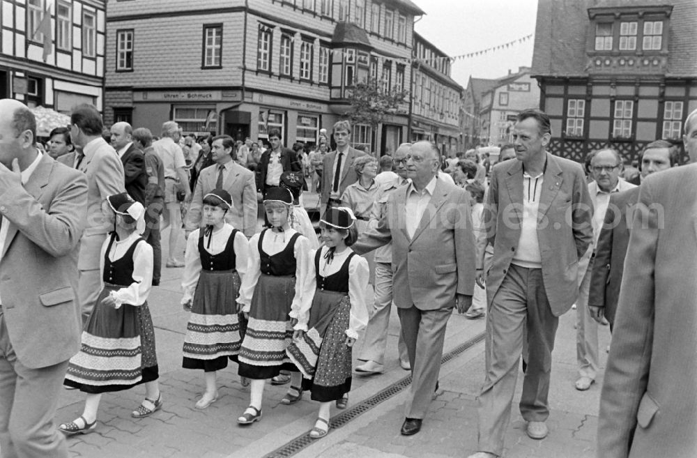 GDR picture archive: Wernigerode - Kurt Hager, the highest cultural official in the SED Politburo, and Werner Eberlein, 1st Secretary of the SED Magdeburg District Leadership, visiting the 21st Workers' Festival in Wernigerode, Saxony-Anhalt in the territory of the former GDR, German Democratic Republic. Girls in typical costumes walk next to the politicians