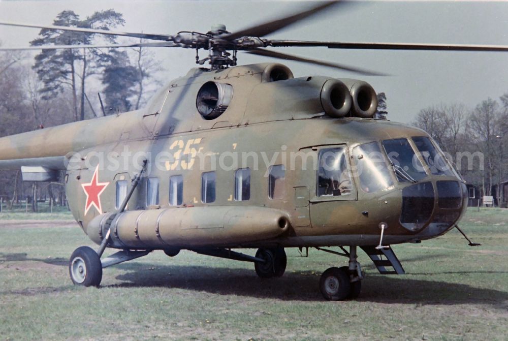 GDR photo archive: Karlshagen - Military variant of the Mil Mi-8 helicopter of the GSSD Group of Soviet Forces in Germany in the saloon variant on the sports field of the NVA office of the LSK/LV Air Force - Air Defense in Karlshagen in the state of Mecklenburg-Western Pomerania on the territory of the former GDR, Germans Democratic Republic
