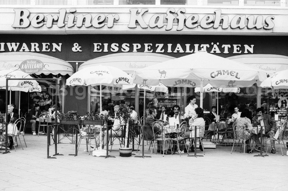 Berlin: Outdoor terrace by the Berlin cafe in Berlin, the former capital of the GDR, the German Democratic Republic. The Berliner coffee house was a restaurant, cafe and ice cream parlor. On the outdoor terrace with parasols advertising