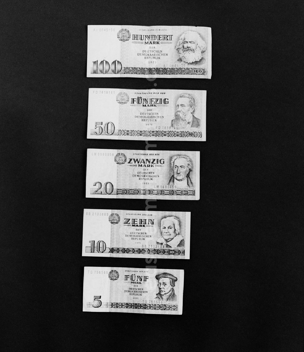 GDR photo archive: Berlin - Various banknotes in stacks on the table of a bank employee as legal tender and currency put into circulation by the State Bank in the Mitte district of Berlin, East Berlin in the territory of the former GDR, German Democratic Republic