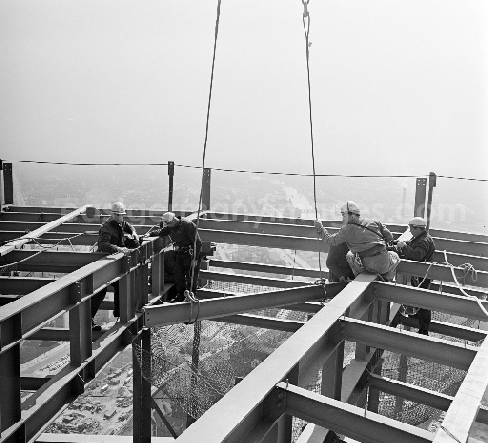 GDR image archive: Berlin - Construction workers secured with ropes and carabiners during steel girder work on the Berlin TV Tower in the district Mitte in Berlin, the former capital of the GDR, German Democratic Republic