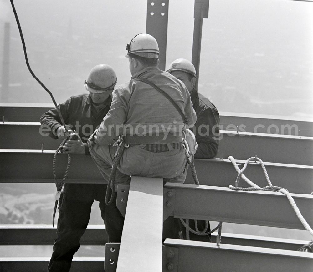 Berlin: Construction workers secured with ropes and carabiners during steel girder work on the Berlin TV Tower in the district Mitte in Berlin, the former capital of the GDR, German Democratic Republic