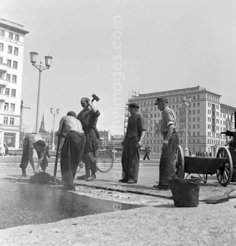 GDR photo archive: Berlin - Road construction work in the newly built Stalinallee (now Karl-Marx-Allee) in the Friedrichshain district of East Berlin in the territory of the former GDR, German Democratic Republic