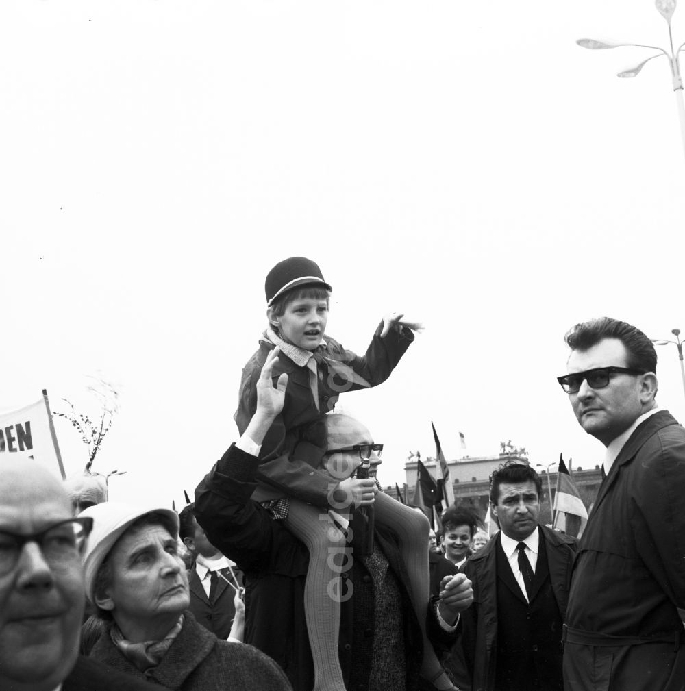 GDR photo archive: Berlin Mitte - Enthusiastic GDR citizens with children and family while parading on the rostrum as the anniversary of the first On May Schlossplatz in Berlin - Mitte