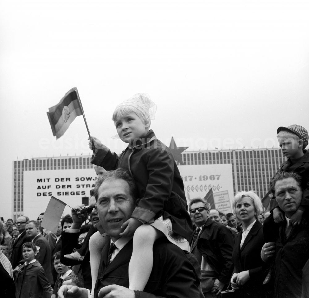 GDR picture archive: Berlin Mitte - Enthusiastic GDR citizens with children and family while parading on the rostrum as the anniversary of the first On May Schlossplatz in Berlin - Mitte