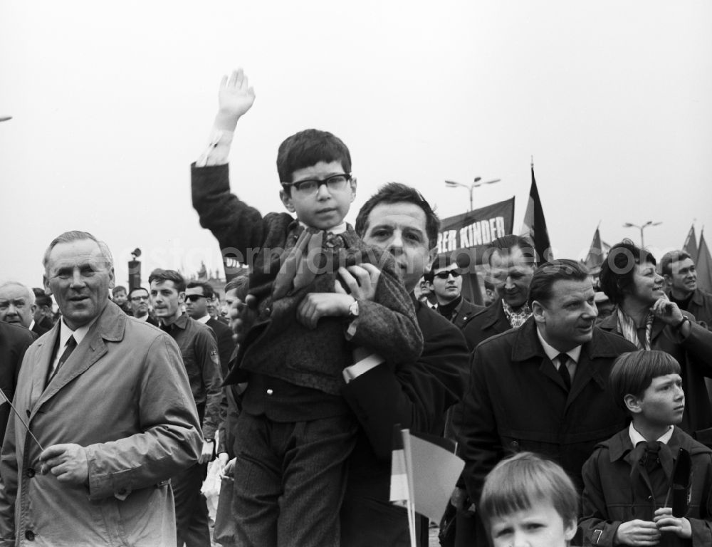 GDR picture archive: Berlin Mitte - Enthusiastic GDR citizens with children and family while parading on the rostrum as the anniversary of the first On May Schlossplatz in Berlin - Mitte