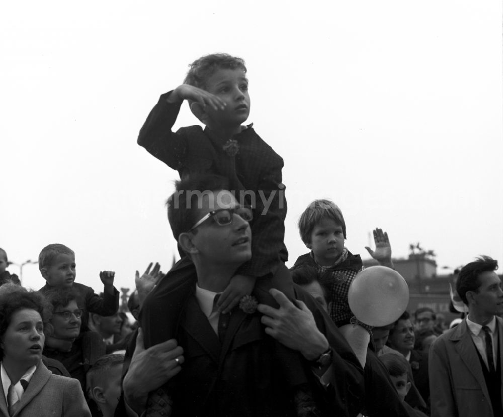 GDR photo archive: Berlin Mitte - Enthusiastic GDR citizens with children and family while parading on the rostrum as the anniversary of the first On May Schlossplatz in Berlin - Mitte