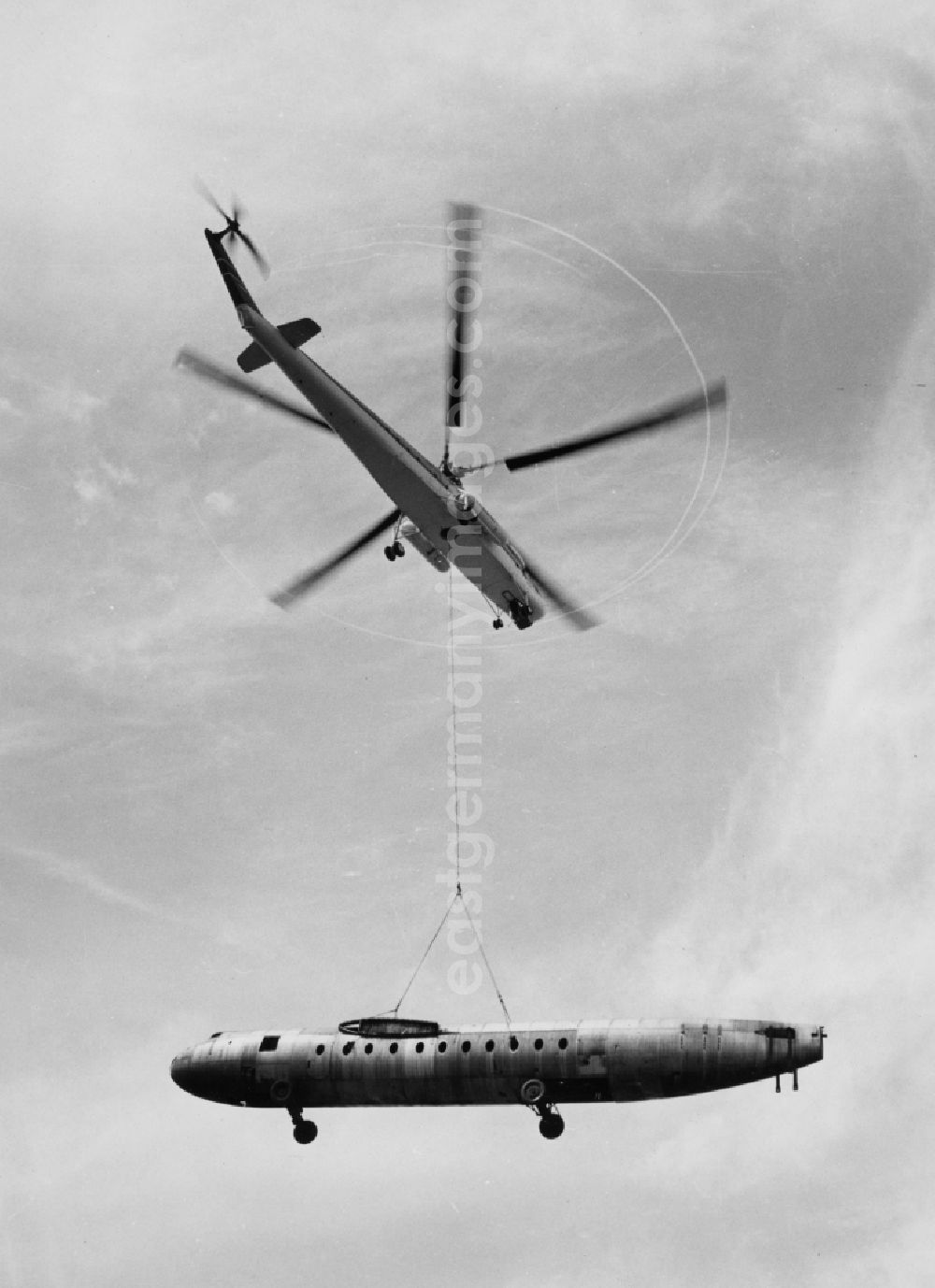 GDR picture archive: Dresden - Ferry flight of an aircraft fuselage 152 of the aircraft production in the GDR VEB Flugzeugwerke Dresden (FWD) with a Soviet Mil Mi-1