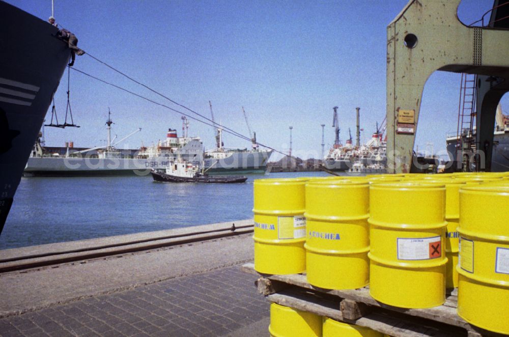GDR picture archive: Rostock - Barrels of the company Roche stand on the overseas port on the Warnow river in Rostock in the state Mecklenburg-Western Pomerania on the territory of the former GDR, German Democratic Republic
