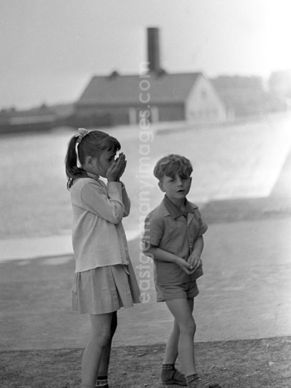 GDR photo archive: Buchenwald - Zwei Kinder bei einer Besichtigung des ehemaligen Konzentrationslagers Buchenwald, das 1958 als Nationale Mahn- und Gedenkstätte eingeweiht worden war. Im Hintergrund das Krematorium.