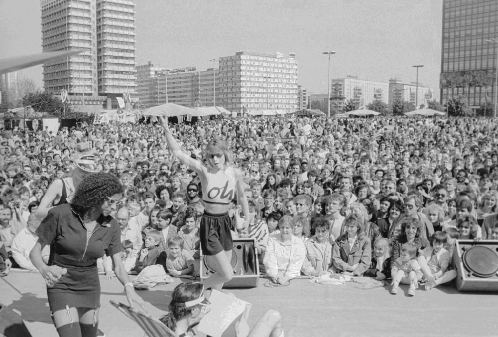 GDR image archive: Berlin - Visitors at stage events at the fair for public entertainment during the 1st of may at the Alexanderplatz in Berlin in Germany