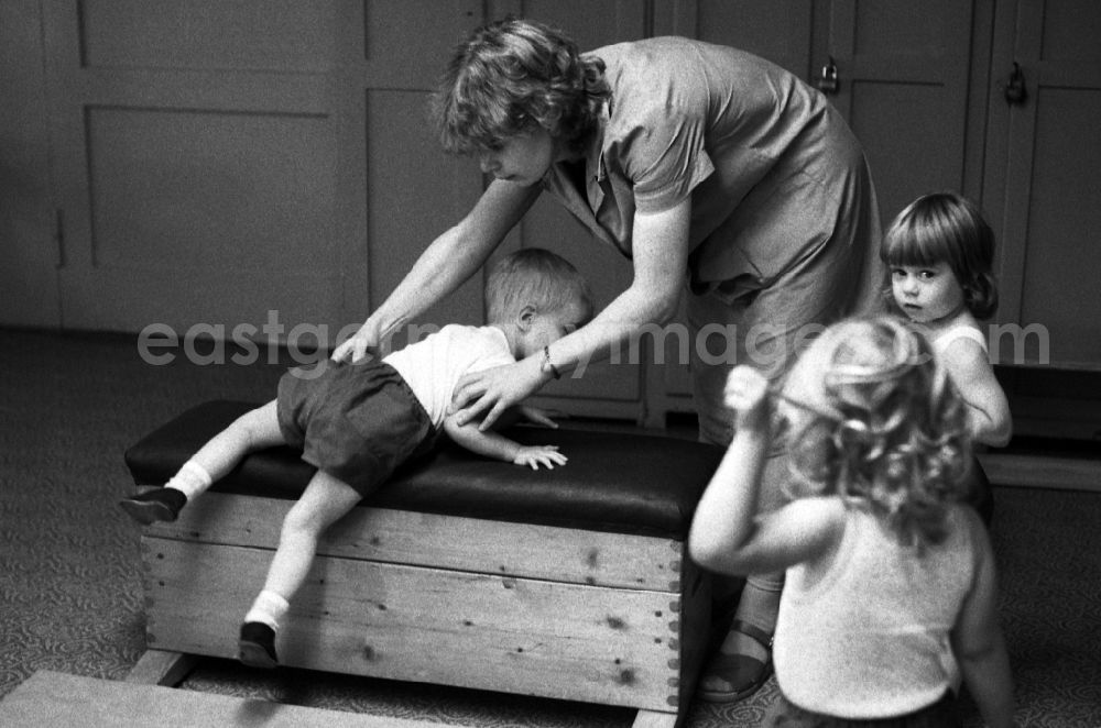 GDR photo archive: Berlin - Games and fun with toddlers in kindergarten in physical education in a gym in Berlin Eastberlin on the territory of the former GDR, German Democratic Republic