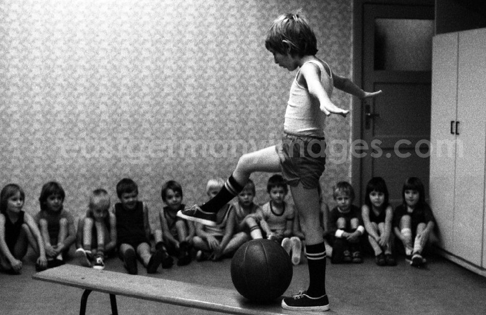 Berlin: Games and fun with toddlers in kindergarten in physical education in a gym in Berlin Eastberlin on the territory of the former GDR, German Democratic Republic
