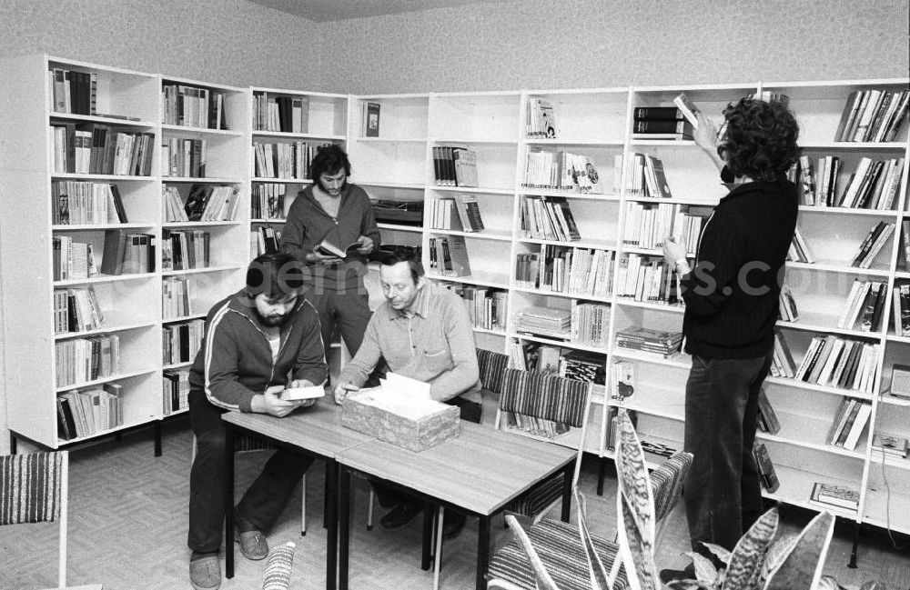 GDR picture archive: Berlin - Blick in die Bibliothek / Freizeitraum des Arbeiterwohnheim an der Rhinstraße / Ecke Landsberger Allee, dem heutigen COMFORT Hotel. Männer sitzen am Tisch bzw. stehen und lesen.
