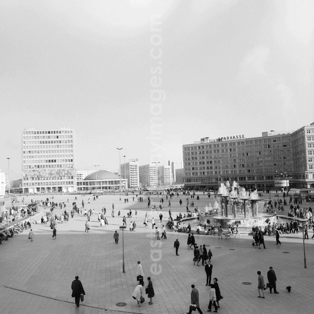 GDR photo archive: Berlin - Look at the Alexanderplatz in Berlin. In the background v.l.n.r. the House of the Teacher, the Berliner Kongresshalle- today the Berlin Congress Center (BCC) and the headquarters of the Berlin Sparkasse- today Landesbank Berlin. In the foreground is the Fountain of International Friendship