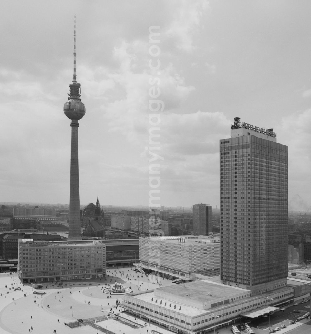 GDR photo archive: Berlin - View at the Alexanderplatz with the TV tower in Berlin - Mitte. In the foreground the Hotel Stadt Berlin (now known as Park Inn by Radisson), behind the Centrum department store (now Galeria Kaufhof) next to the Alexander House and the S- and U-Bahn station Alexanderplatz. Centrally located in the middle of Alexanderplatz find the Fountain of Friendship of Nations