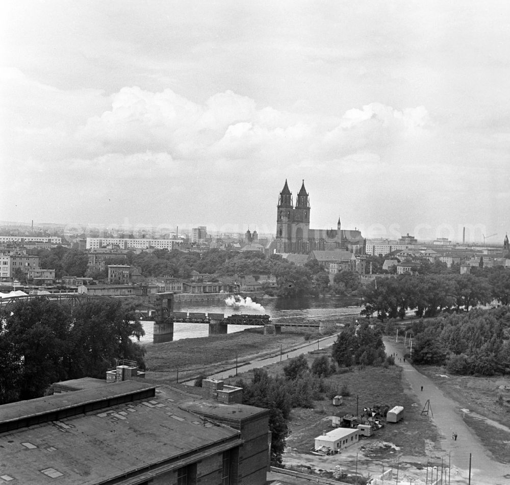 GDR photo archive: Magdeburg - View at the lift bridge in Magdeburg in Saxony - Anhalt. The lift bridge Magdeburg is a single-track railway bridge spanning the Elbe in Magdeburg. She is one of the oldest and largest movable bridges in Germany. In the background is the Cathedral of Magdeburg