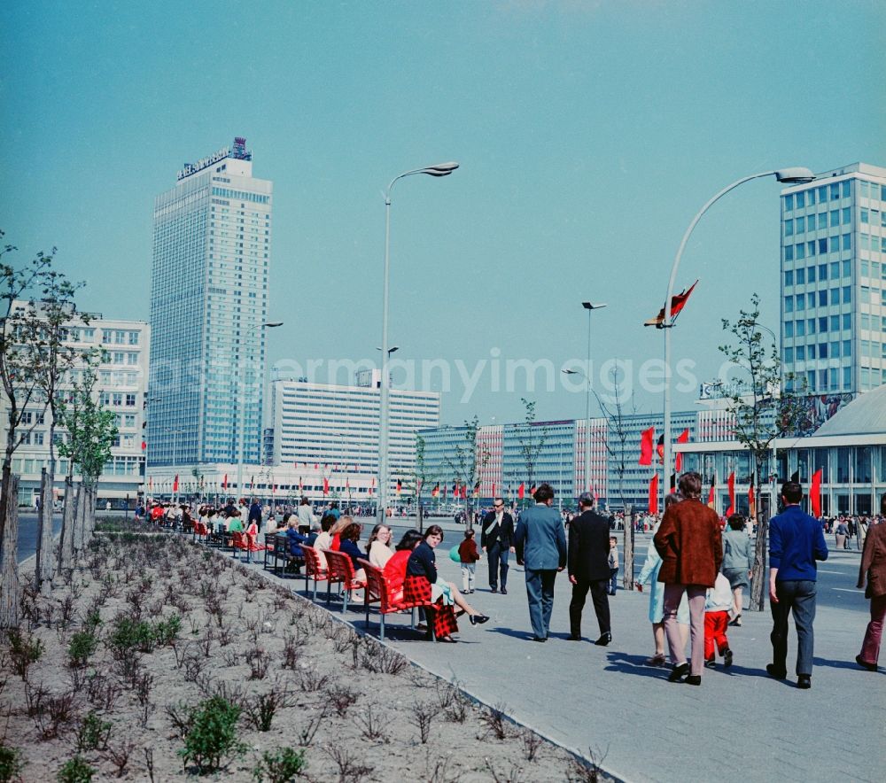 GDR photo archive: Berlin - View in the direction of the Berliner Verlag decorated with flags Alexander street in Berlin. On the left is the Hotel Stadt Berlin