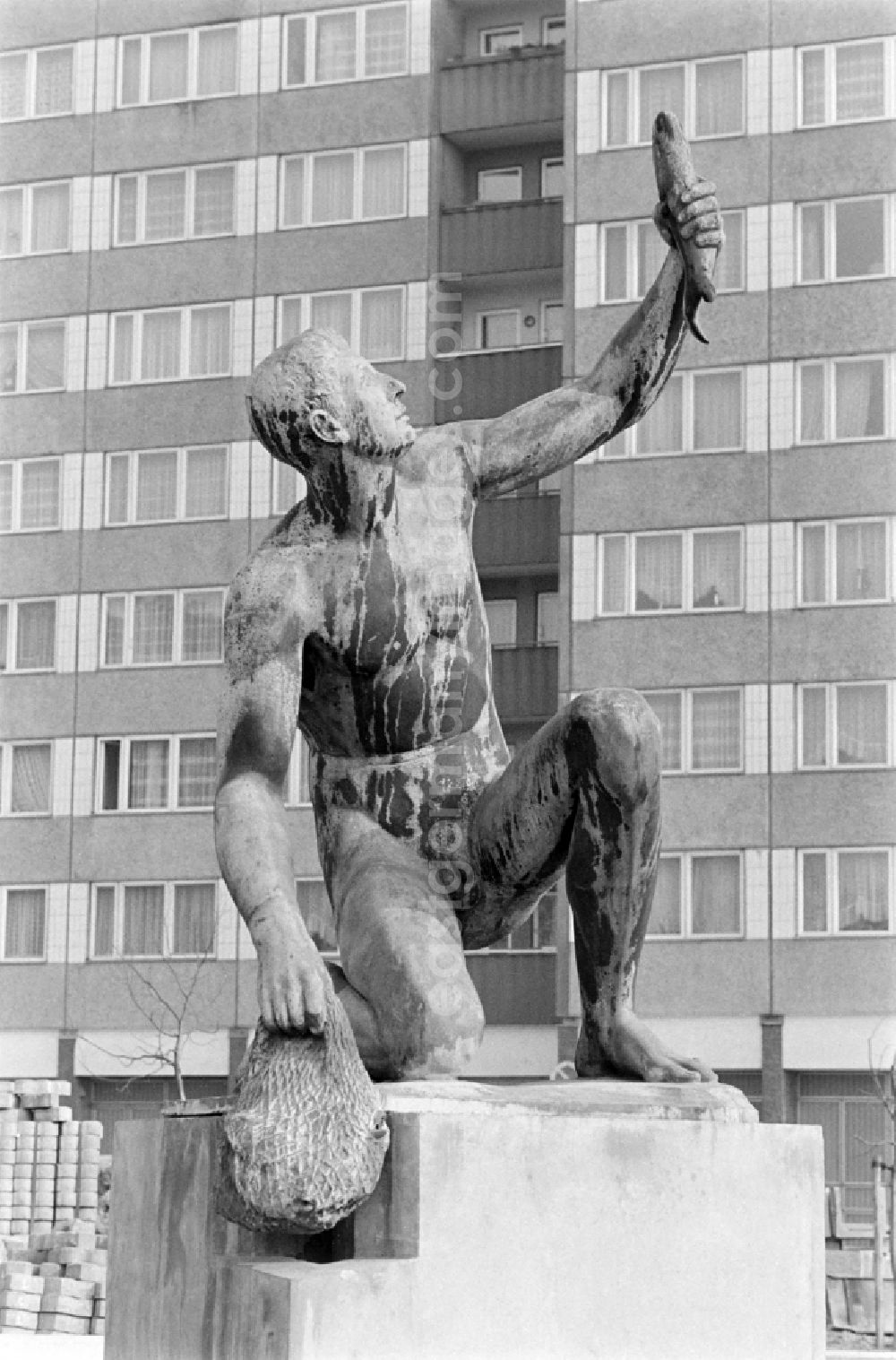 GDR picture archive: Berlin - Fountain with bronze figure Young man with fish by Hans Latt near Frankfurter Allee corner Moellendorffstrasse in Berlin Eastberlin on the territory of the former GDR, German Democratic Republic