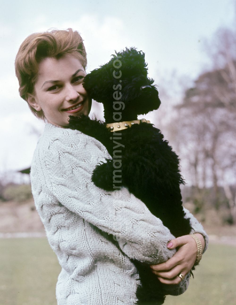 Berlin: Actress Christine Laszar with poodle in the park in East Berlin on the territory of the former GDR, German Democratic Republic
