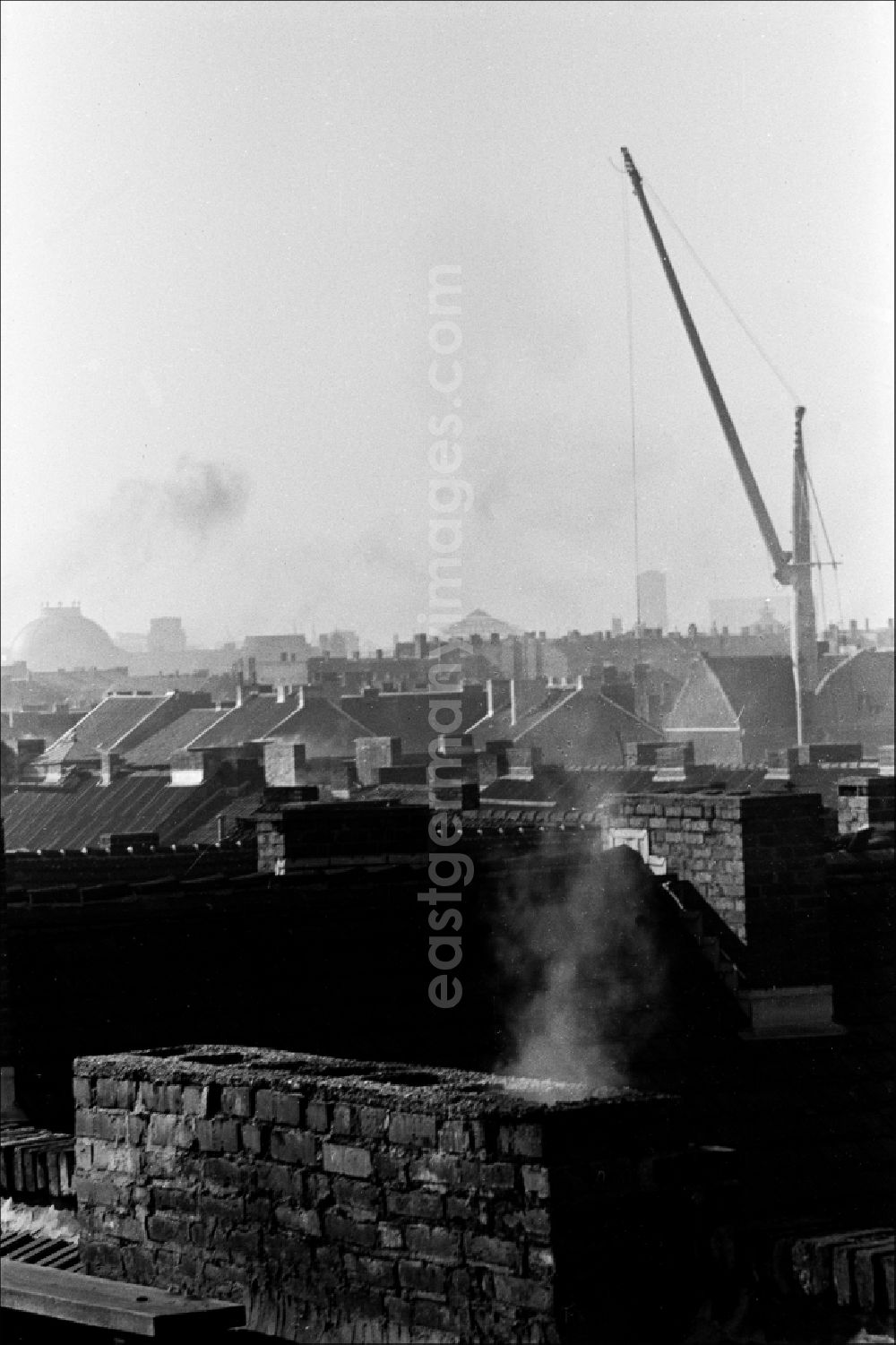 GDR photo archive: Berlin - View over the roofs in winter during the heating season in East Berlin on the territory of the former GDR, German Democratic Republic