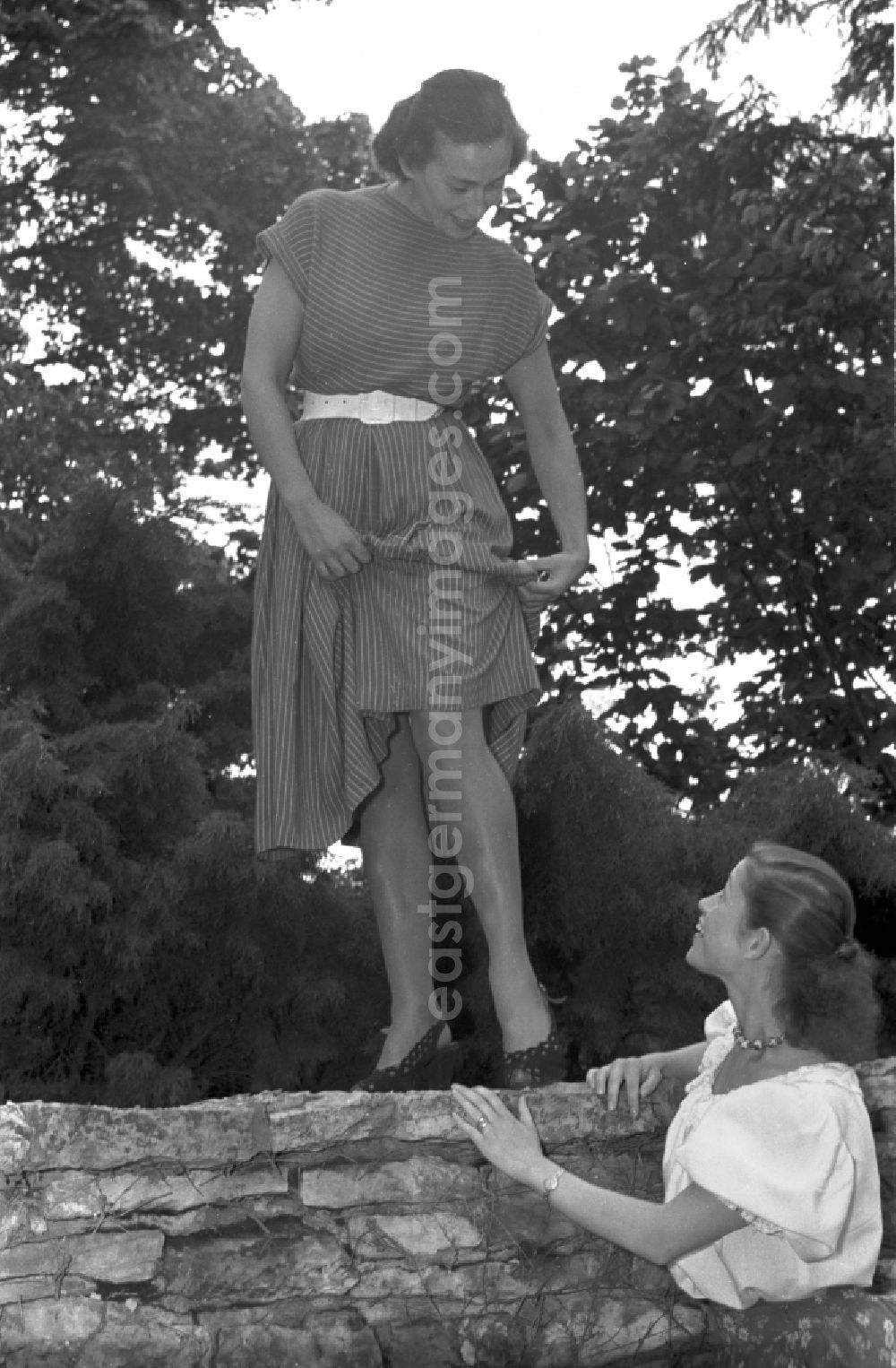 GDR photo archive: Berlin - Young woman presents current women's fashion collection mit Nylonstruempfen - Perlonstruempfen in the district Friedrichshain in Berlin Eastberlin on the territory of the former GDR, German Democratic Republic