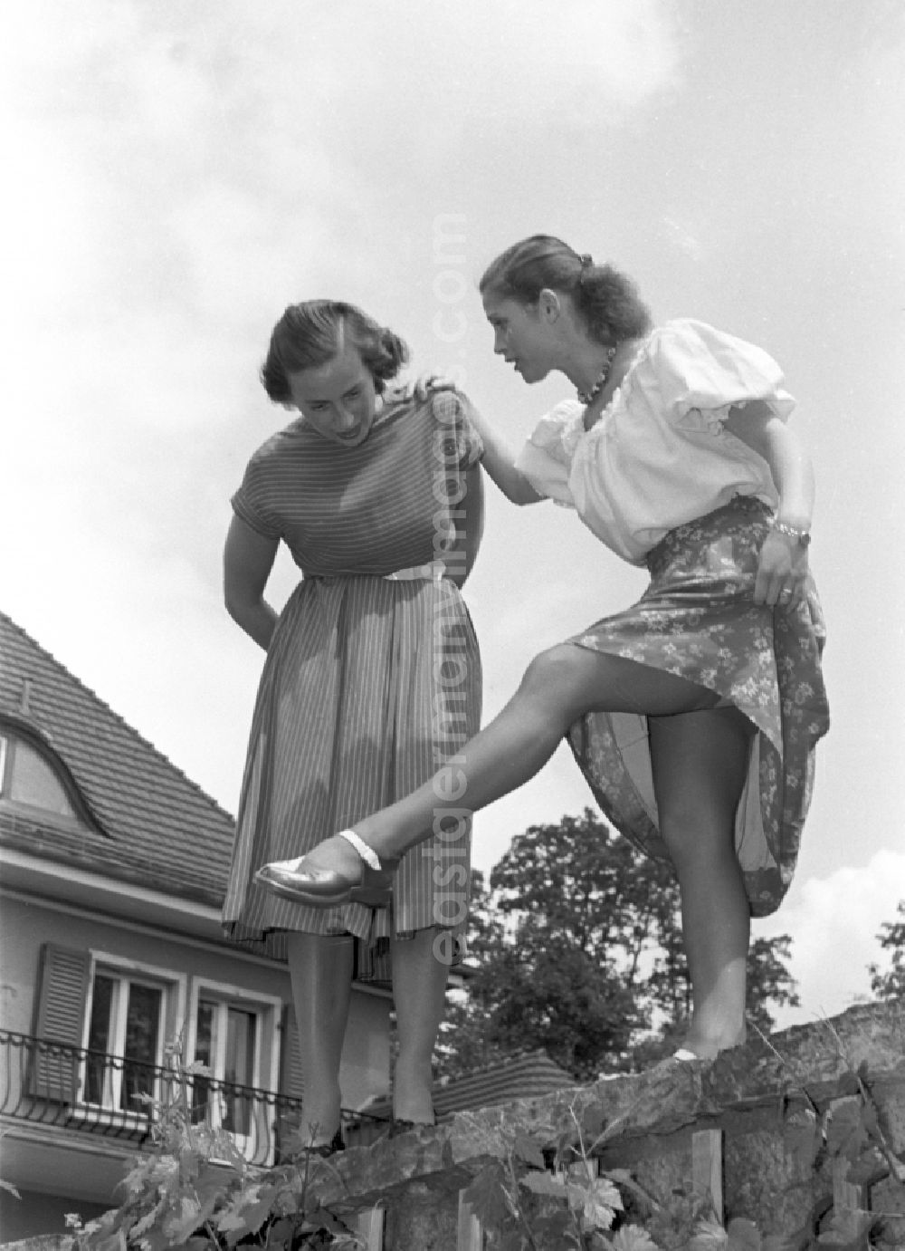 GDR photo archive: Berlin - Young woman presents current women's fashion collection mit Nylonstruempfen - Perlonstruempfen in the district Friedrichshain in Berlin Eastberlin on the territory of the former GDR, German Democratic Republic