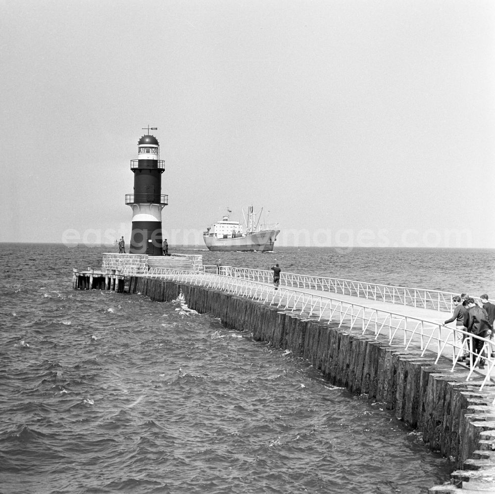 GDR picture archive: Warnemünde - The cargo ship Krasnoye Selo moves in Warnemuende at the pier and the lighthouse passing towards the port of Rostock