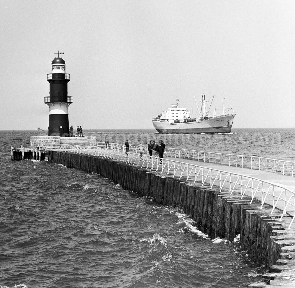 GDR picture archive: Rostock - The cargo ship Krasnoye Selo moves in Warnemuende at the pier and the lighthouse passing towards the port of Rostock