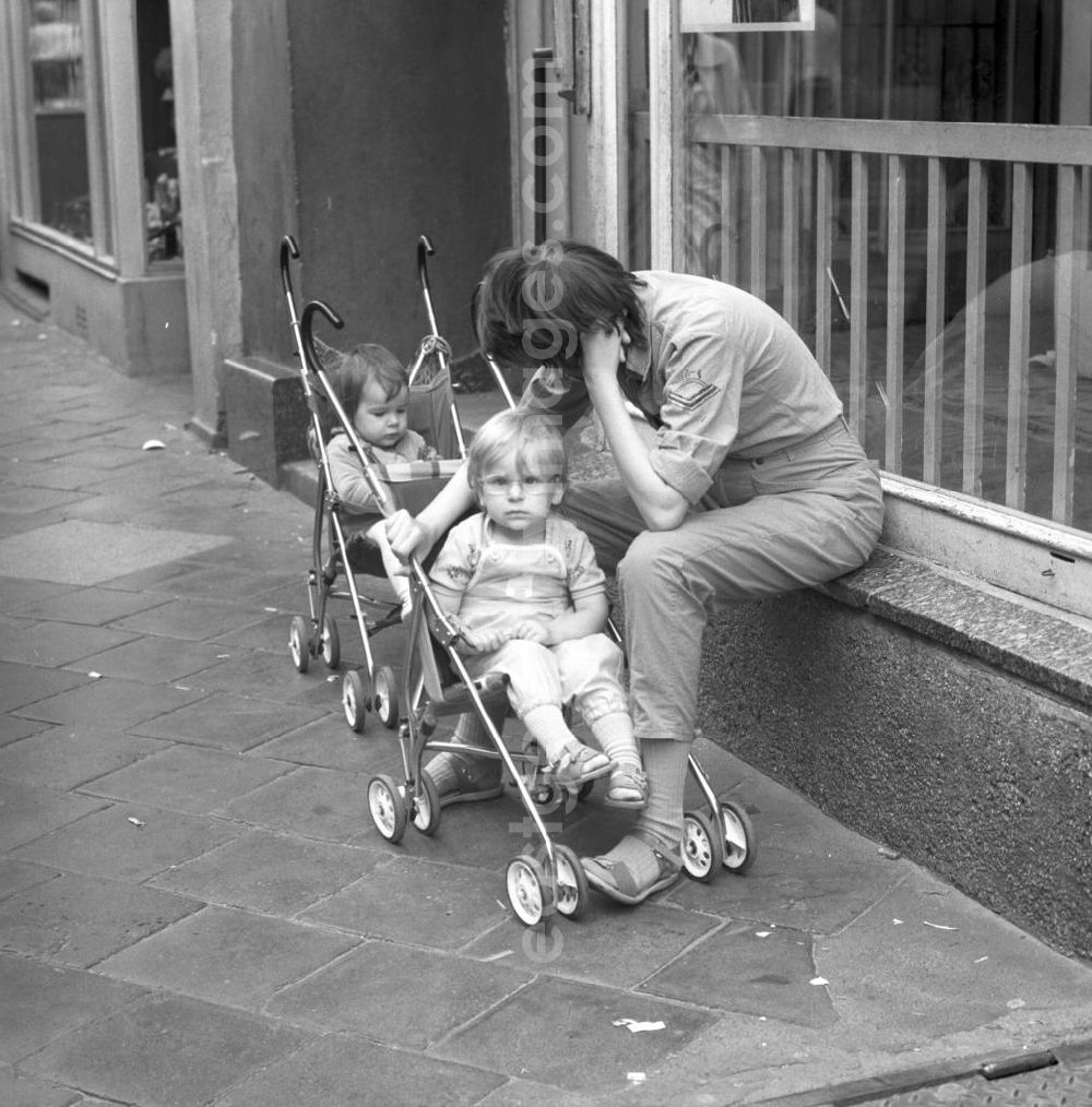GDR photo archive: Rostock - Straßenszene in der Rostocker Altstadt. Frau / Mutter mit Kind / Kinder im Kinderwagen.