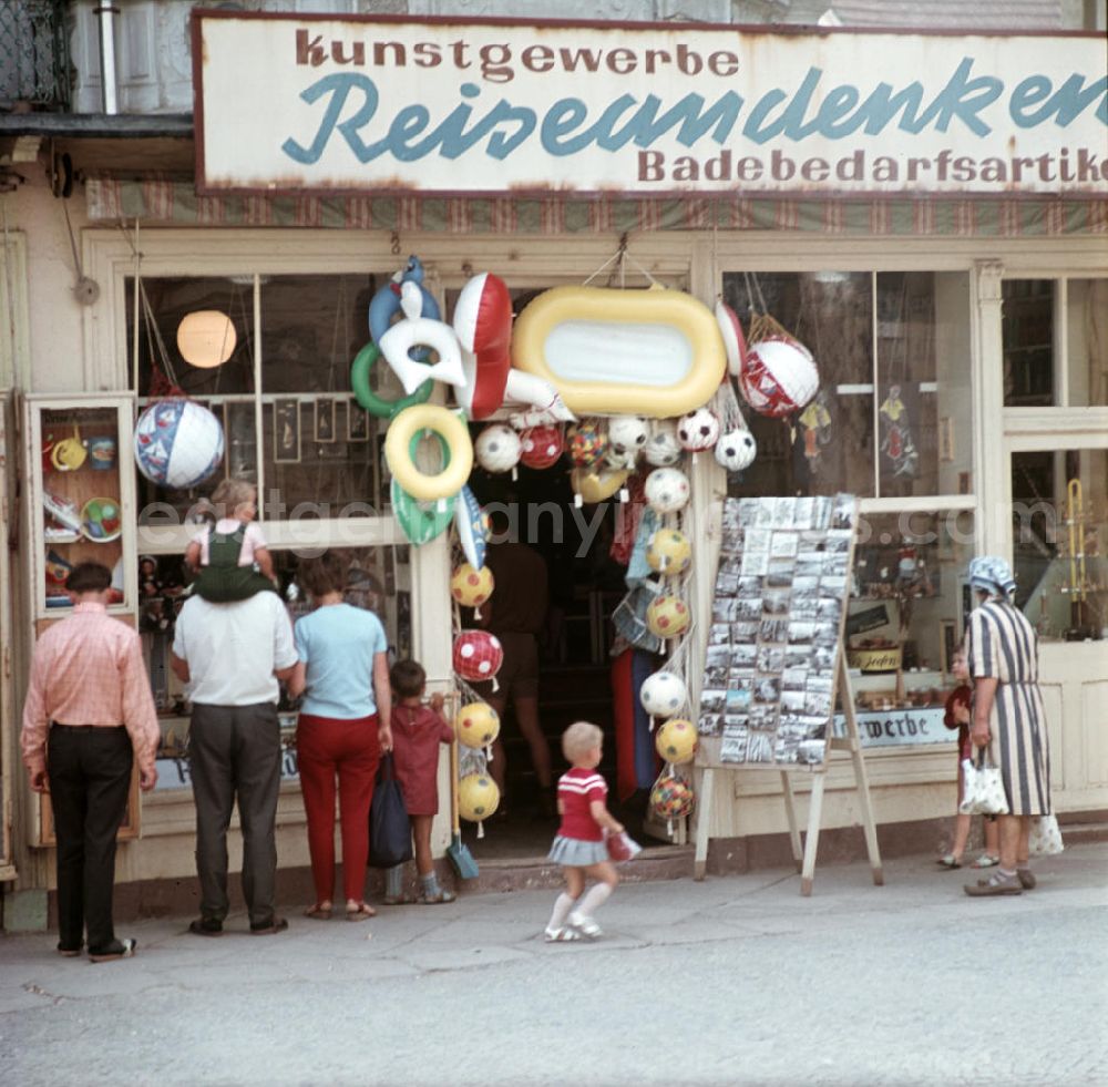 GDR picture archive: Ahlbeck - Urlauber betrachten die Schaufenster eines Geschäftes für Kunstgewerbe, Reiseandenken und Badebedarfsartikel in Ahlbeck auf der Insel Usedom.