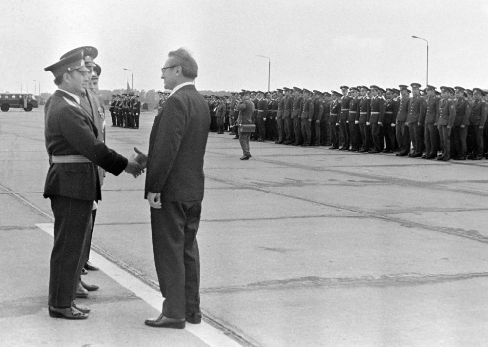 GDR image archive: Ribnitz-Damgarten - Kurt Thieme (General Secretary of the Central Board of the Society for German-Soviet Friendship DSF) with an NVA Air Force delegation at the awarding of a ribbon of honor to the troop flag of the officers of the GSSD Group of Soviet Armed Forces in Germany at the airfield in Ribnitz-Damgarten, Mecklenburg- Western Pomerania in the territory of the former GDR, German Democratic Republic