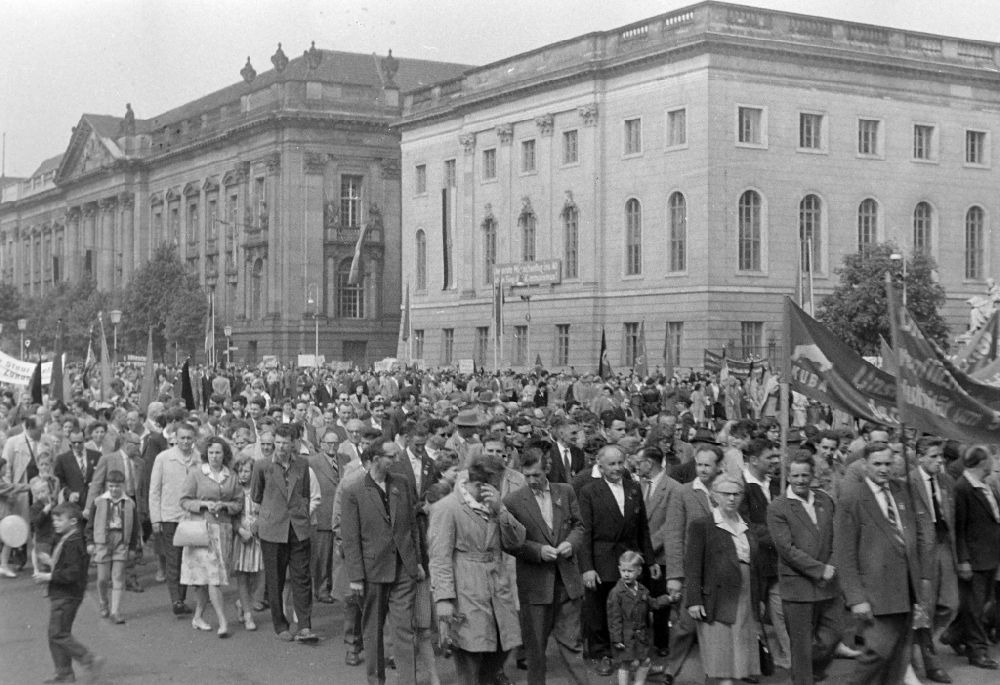 GDR photo archive: Berlin - Participants of the May 1st demonstration with the portrait photos of Nikita Khrushchev and Otto Grothewohl on the streets of the city center on the B2 street in the Mitte district of Berlin East Berlin on the territory of the former GDR, German Democratic Republic