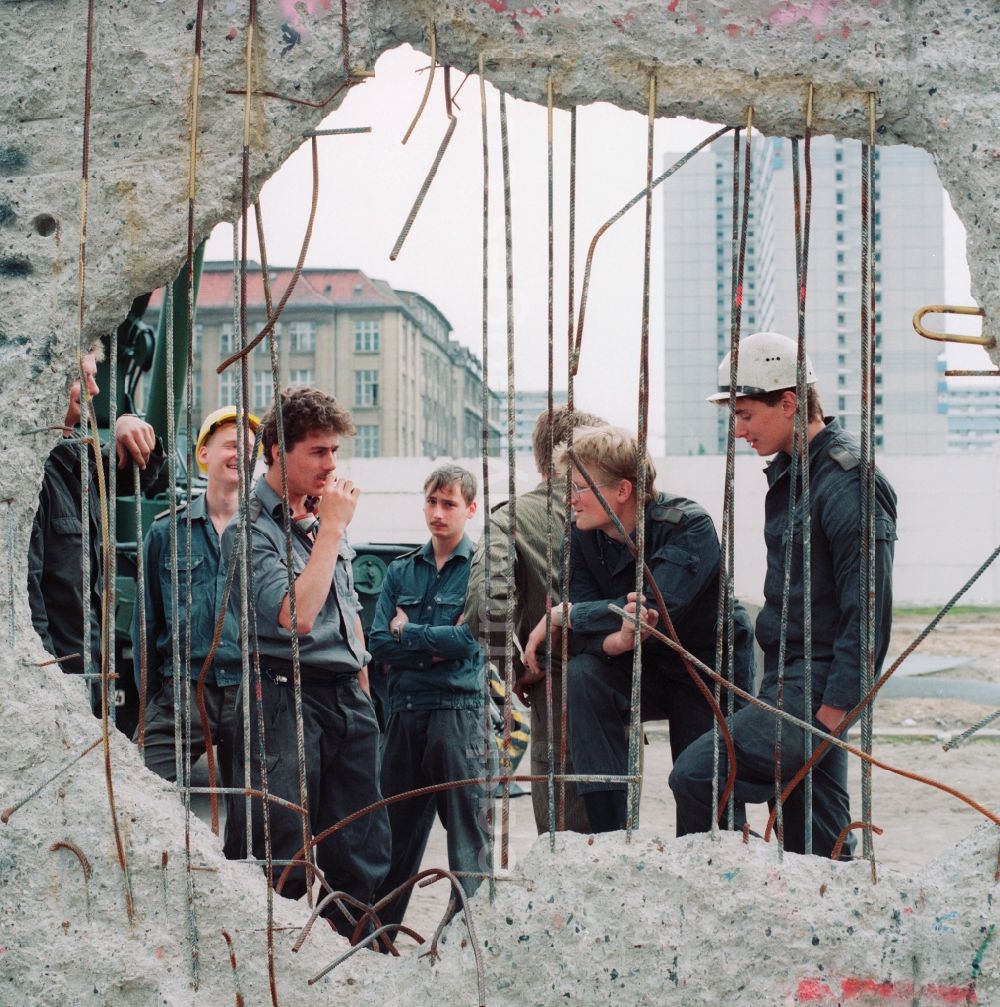 GDR image archive: Berlin - Construction pioneers and soldiers of the GDR border troops dismantle concrete segments with steel reinforcements from the ehmaligen fortification of the GDR border to West Berlin in Berlin the former capital of the GDR