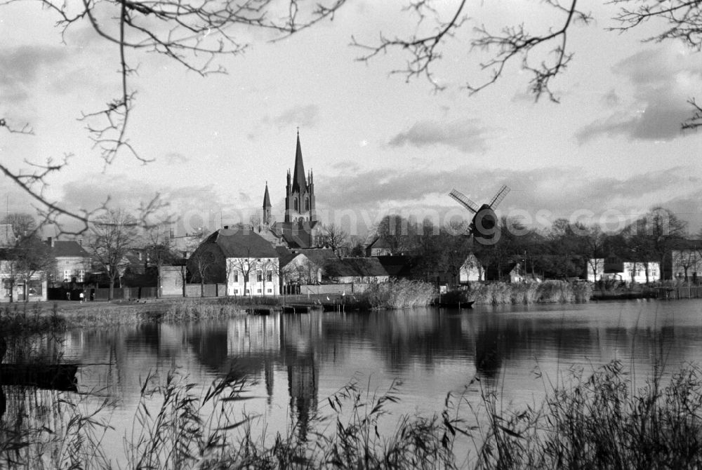 GDR picture archive: Werder an der Havel - View from the banks of the Havel to the windmill in Werder upon Havel in Brandenburg. In the left background is the Protestant Church of Holy Spirit