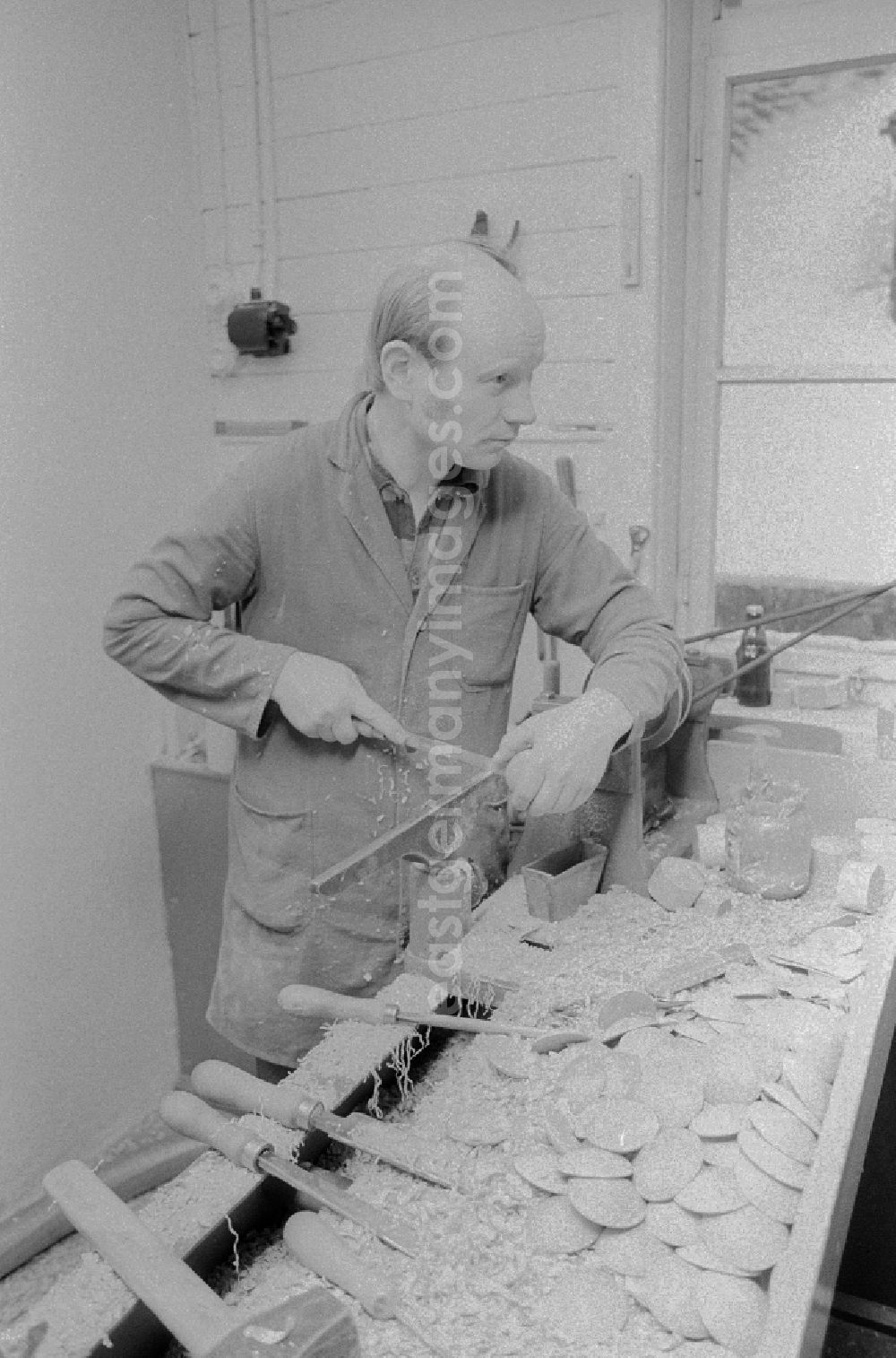 GDR photo archive: Seiffen - Wood turner in the production of nut crackers in the workshops VERO in the health resort Seiffen in the federal state Saxony in the area of the former GDR, German democratic republic