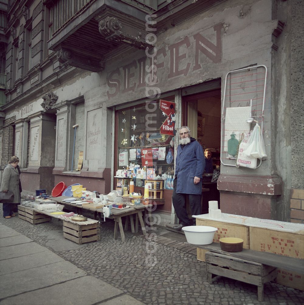 GDR picture archive: Berlin - Gray-bearded dealer and owner of a soap shop - drugstore on Marienburger Strasse in front of his shop door in the Boetzowviertel district in Berlin East Berlin on the territory of the former GDR, German Democratic Republic