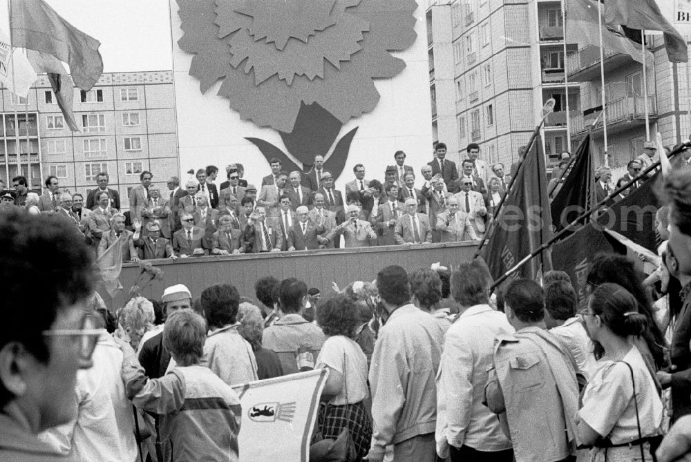 GDR photo archive: Berlin - Participants from all social classes and sections of the population as a large demonstration pay homage to the members of the party and state leadership on the specially built honorary stage for May 1st on Karl-Marx-Allee (Stalinallee) in the city center in the Mitte district of Berlin in East Berlin in the area the former GDR, German Democratic Republic