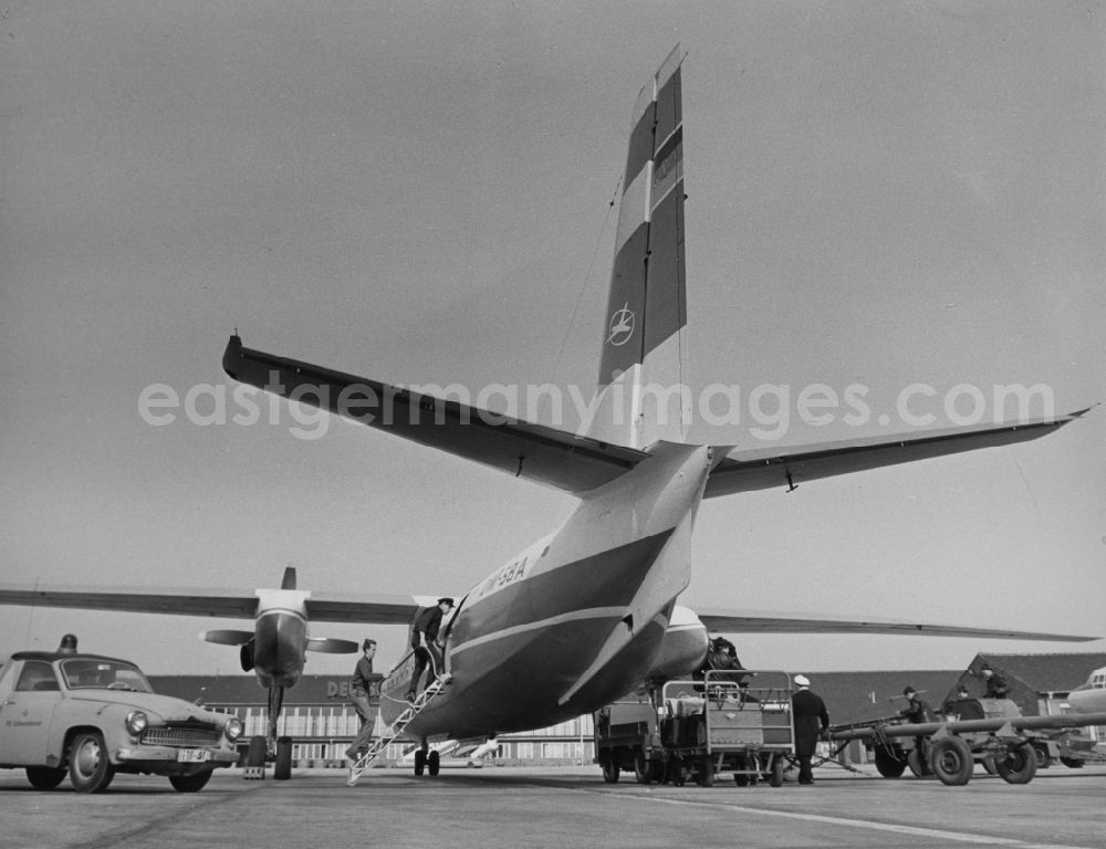 GDR image archive: Schönefeld - An aircraft of type AN-24 INTERFLUG is loaded with luggage and refueled in Schoenefeld in today's Brandenburg. The Antonov An-24 is a short-haul passenger and cargo aircraft of Soviet origin