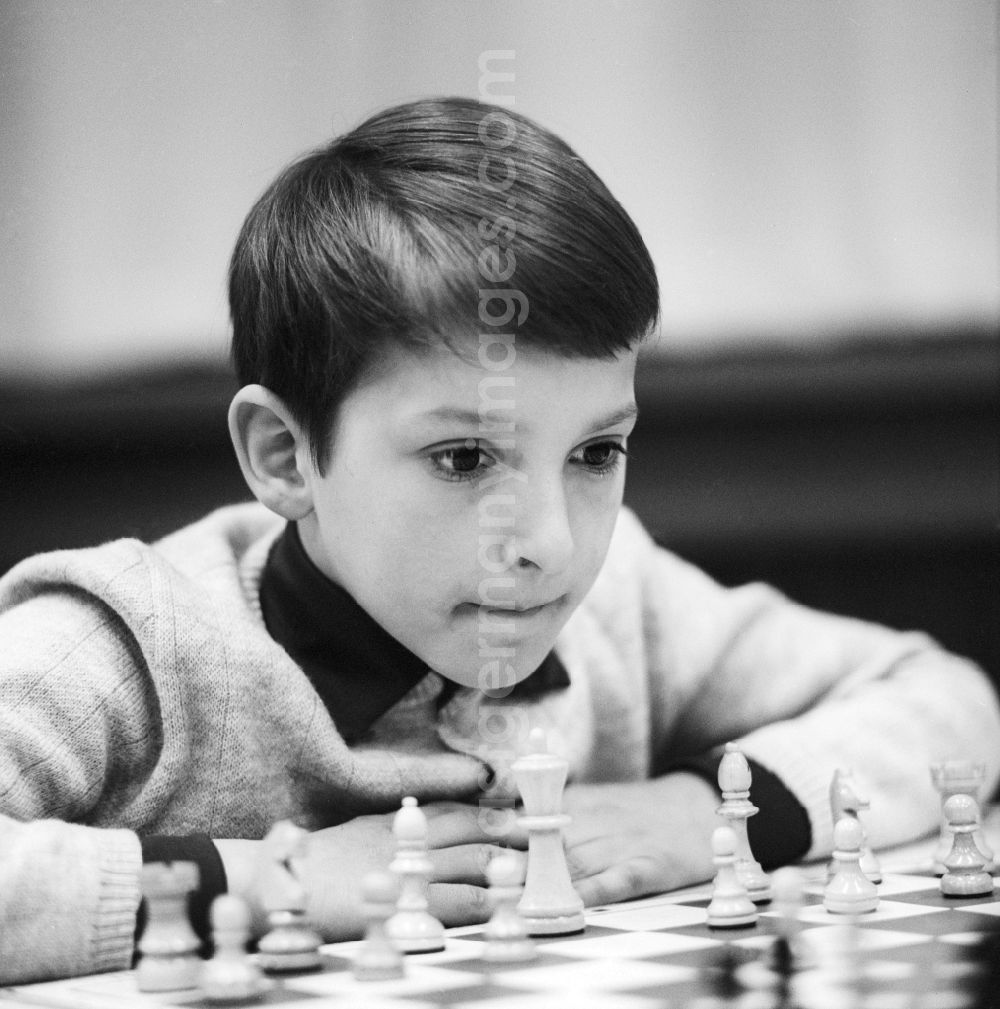GDR picture archive: Strausberg - A boy playing chess highly concentrated in Strausberg in Brandenburg on the territory of the former GDR, German Democratic Republic
