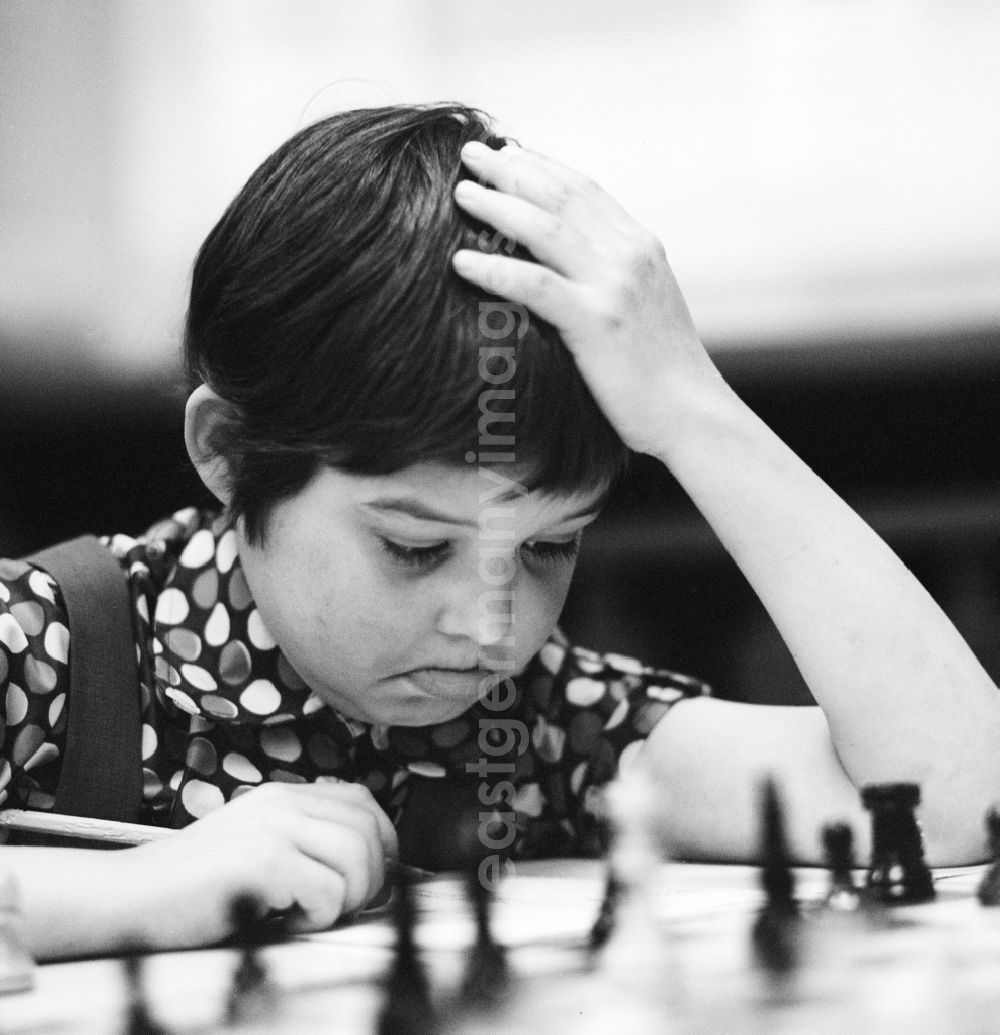 Strausberg: A boy playing chess highly concentrated in Strausberg in Brandenburg on the territory of the former GDR, German Democratic Republic