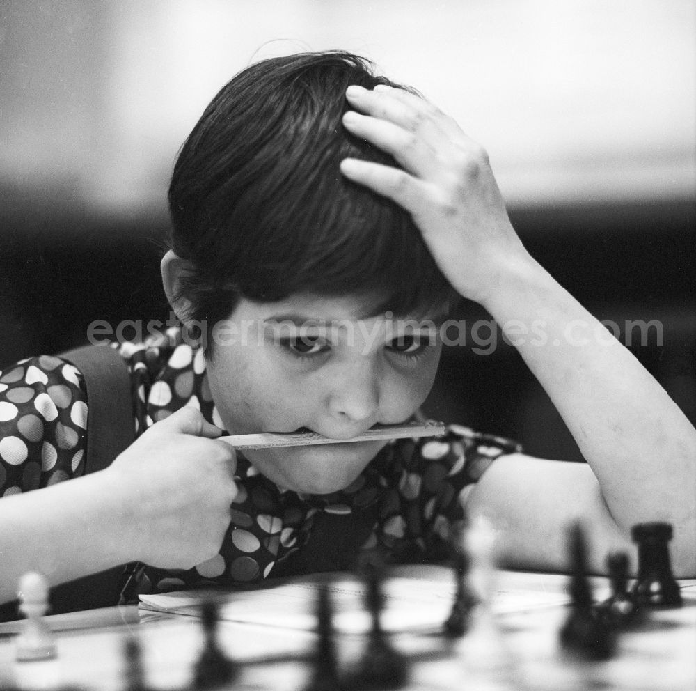 GDR photo archive: Strausberg - A boy playing chess highly concentrated in Strausberg in Brandenburg on the territory of the former GDR, German Democratic Republic