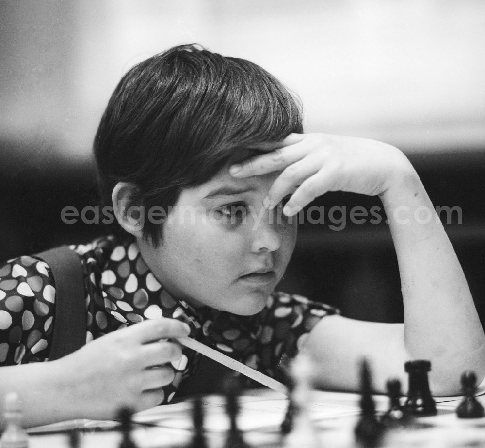GDR picture archive: Strausberg - A boy playing chess highly concentrated in Strausberg in Brandenburg on the territory of the former GDR, German Democratic Republic