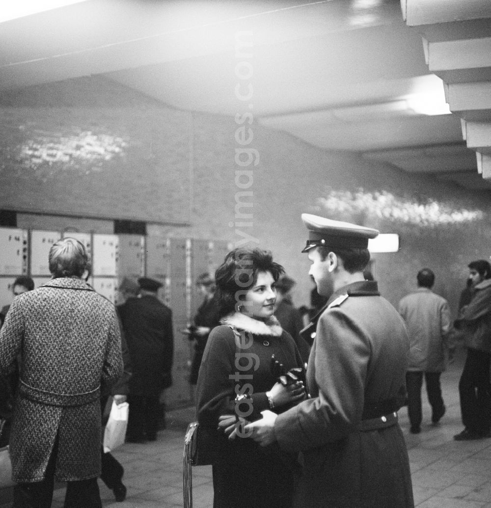 Berlin: A young couple in love in Berlin, the former capital of the GDR, German Democratic Republic. A soldier of the National People's Army (NVA) meets with his girlfriend in the basement of a train station in front of the lockers