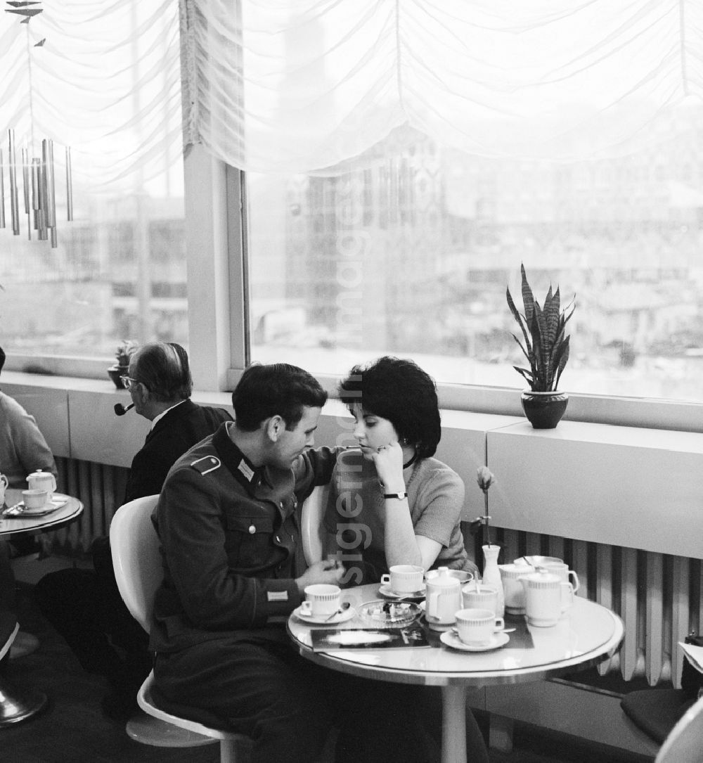 GDR photo archive: Berlin - A soldier of the National People's Army (NVA) meets with his girlfriend in a cafe in Berlin, the former capital of the GDR, German Democratic Republic