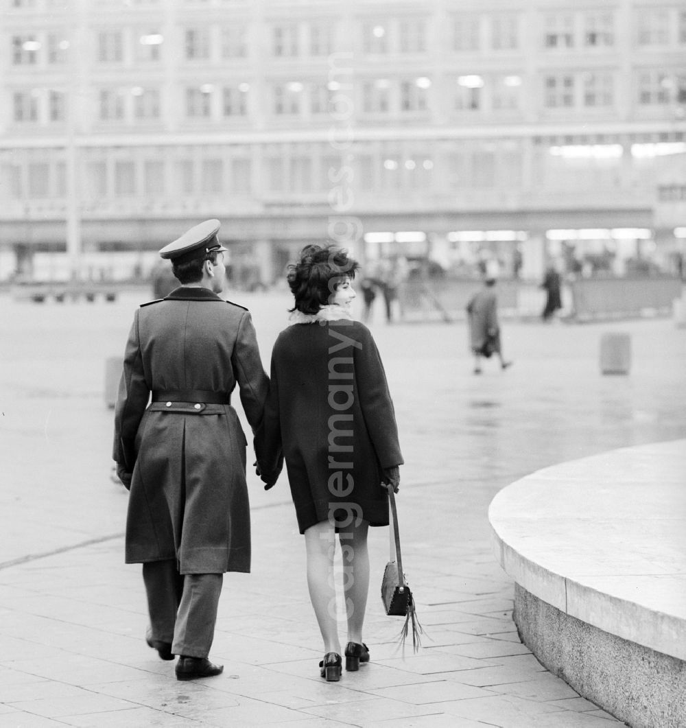 GDR picture archive: Berlin - A soldier of the National People's Army (NVA) goes with his girlfriend on the Alexanderplatz in Berlin for a walk, the former capital of the GDR, German Democratic Republic