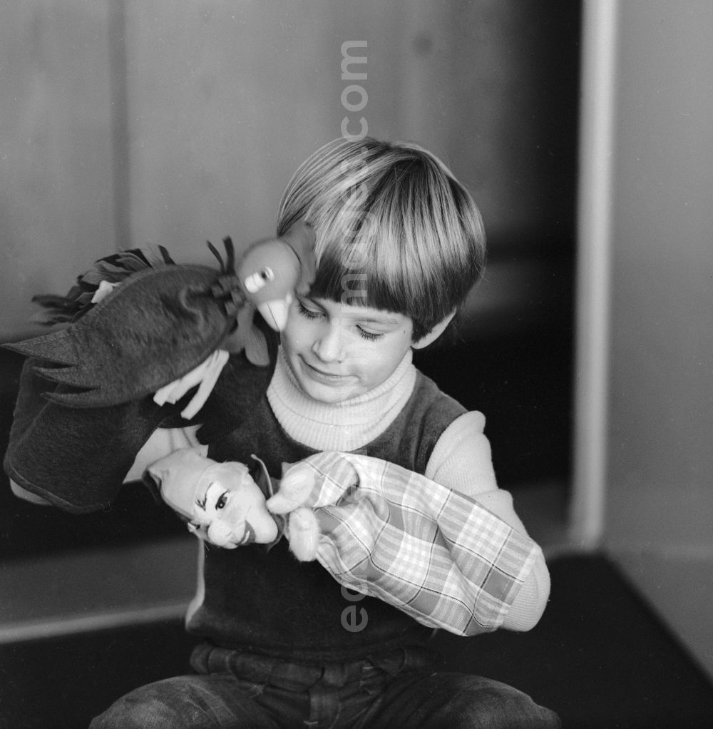 GDR photo archive: Berlin - A child playing with hand puppets in Berlin, the former capital of the GDR, the German Democratic Republic