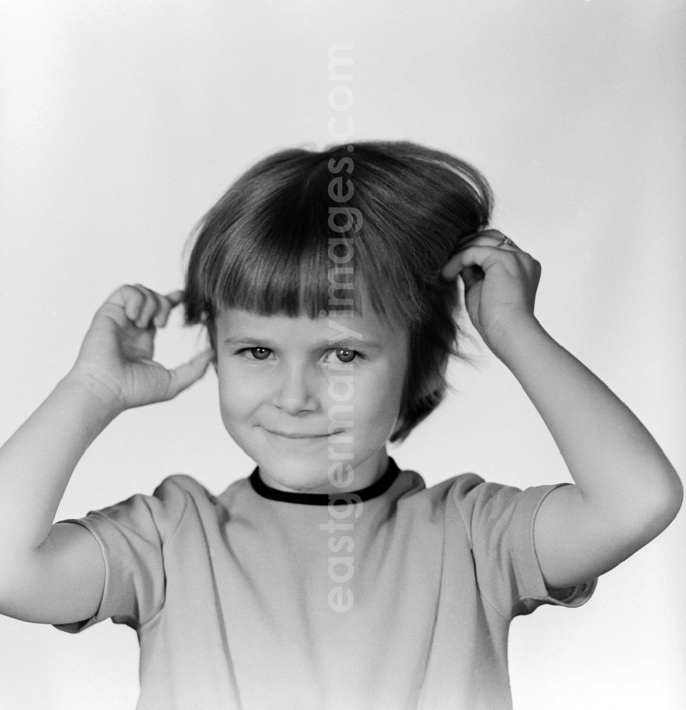 GDR photo archive: Berlin - A small child tearing her hair in Berlin, the former capital of the GDR, the German Democratic Republic